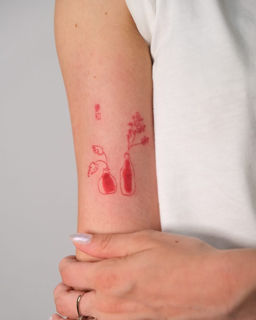 Intricate Red Ink Representation of Hands Tattoo Design