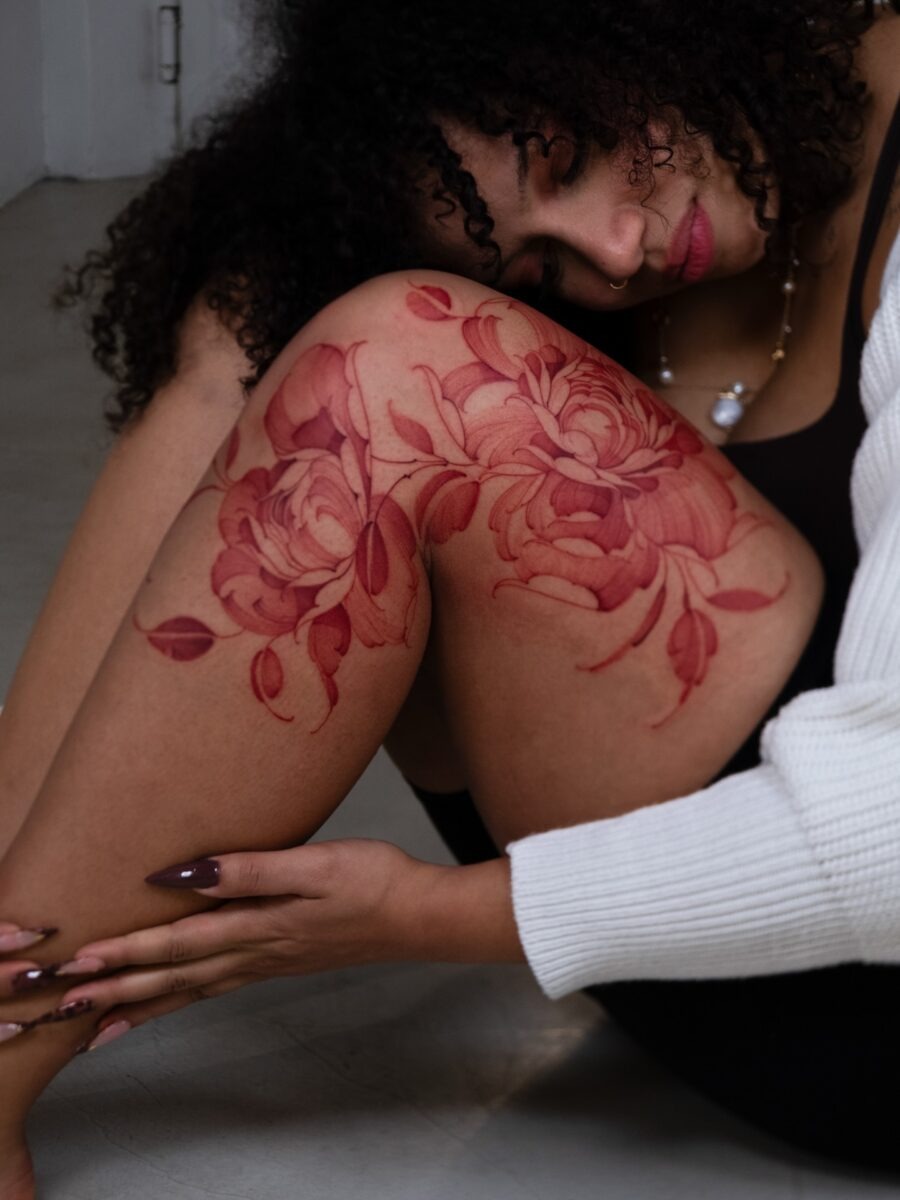 Striking red fish tattoo with unique elements Tattoo Design