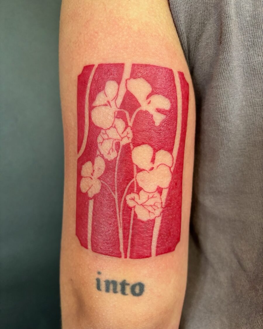 Striking red ink floral tattoo on the arm Tattoo Design