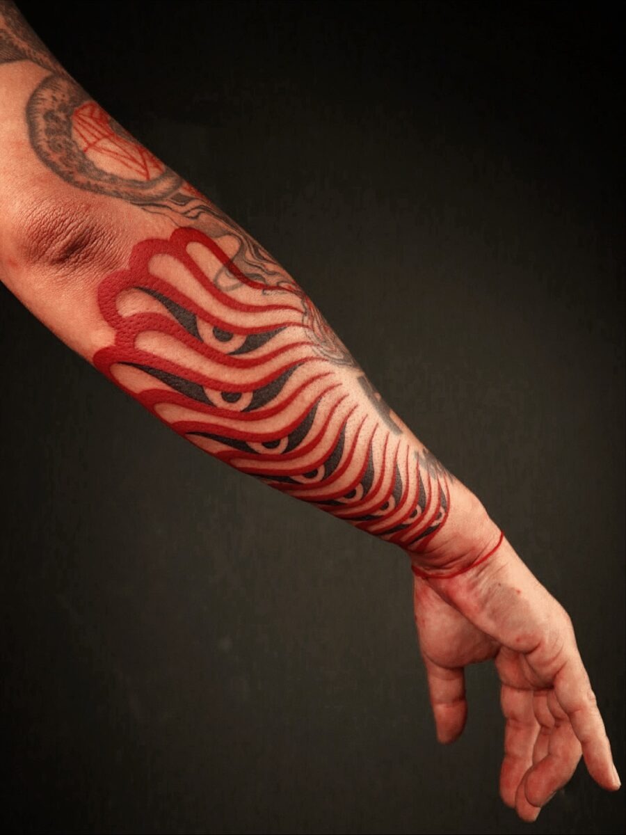 Striking Red Ink Tattoo on Forearm Tattoo Design
