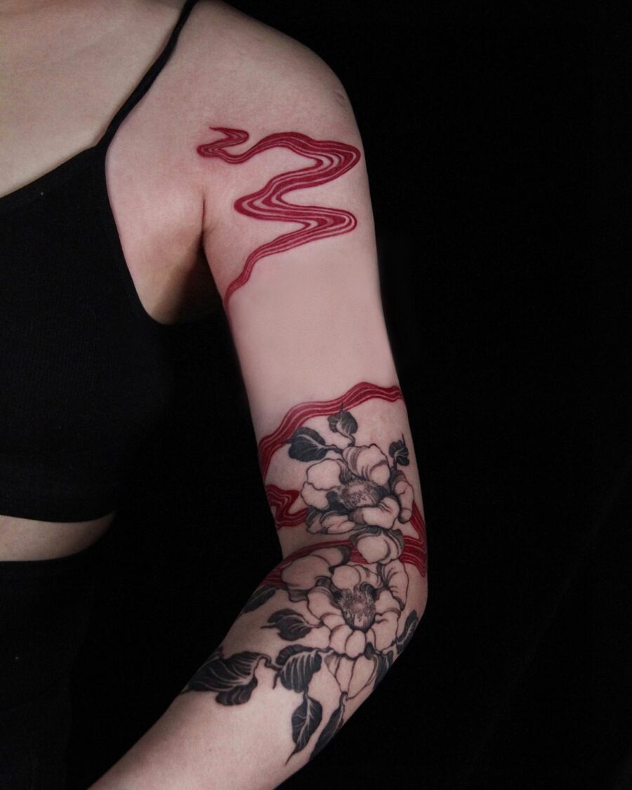 Stunning red floral tattoo on the arm Tattoo Design