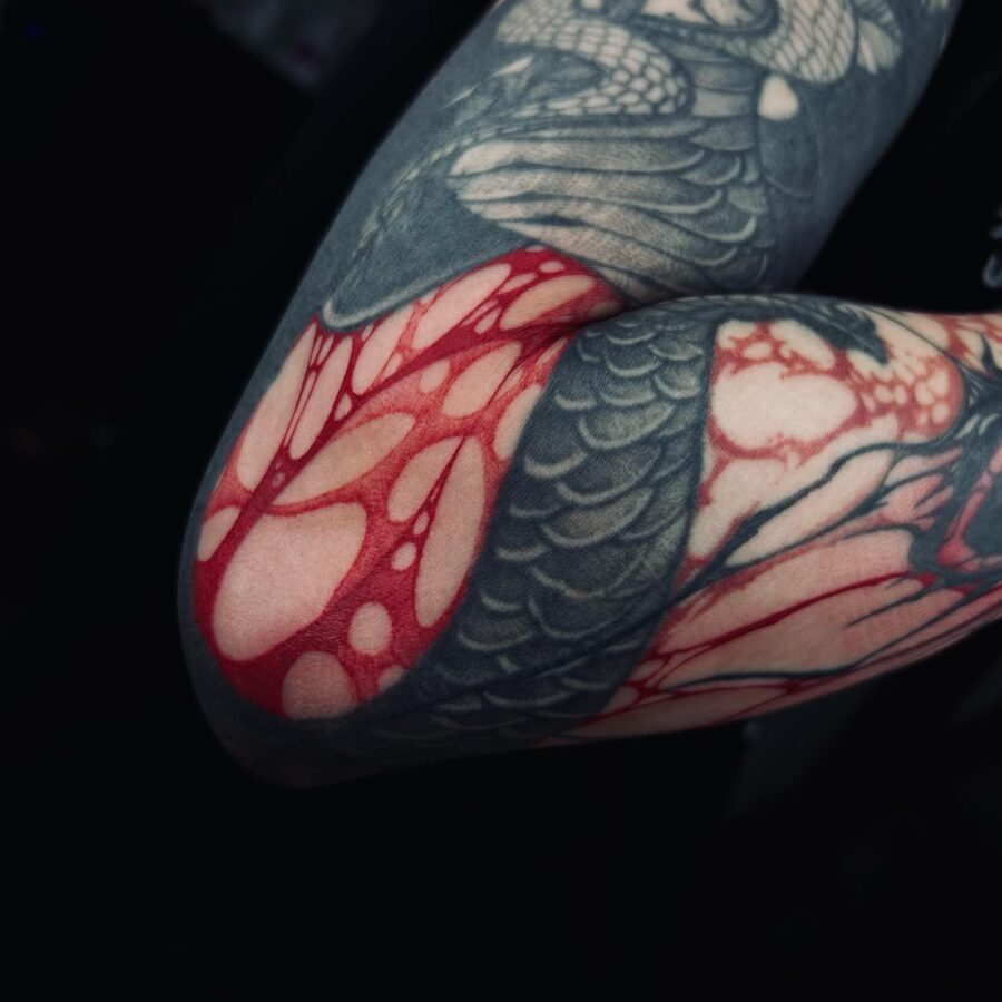 Vibrant red heart tattoo with floral accents Tattoo Design