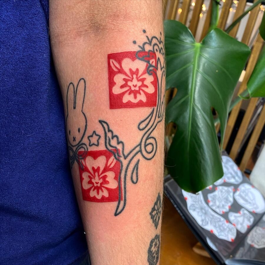 Vibrant red ink sun tattoo on hand Tattoo Design