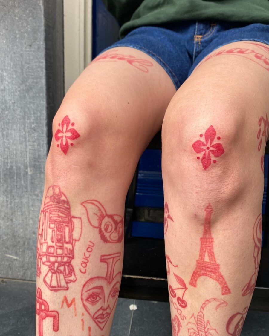 Vibrant red ink tattoo designs on legs Tattoo Design