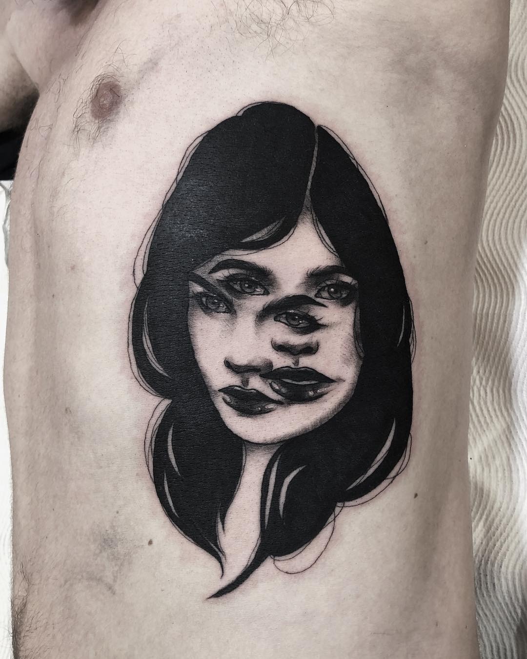 Artistic Rib Tattoo of Mysterious Faces Tattoo Design