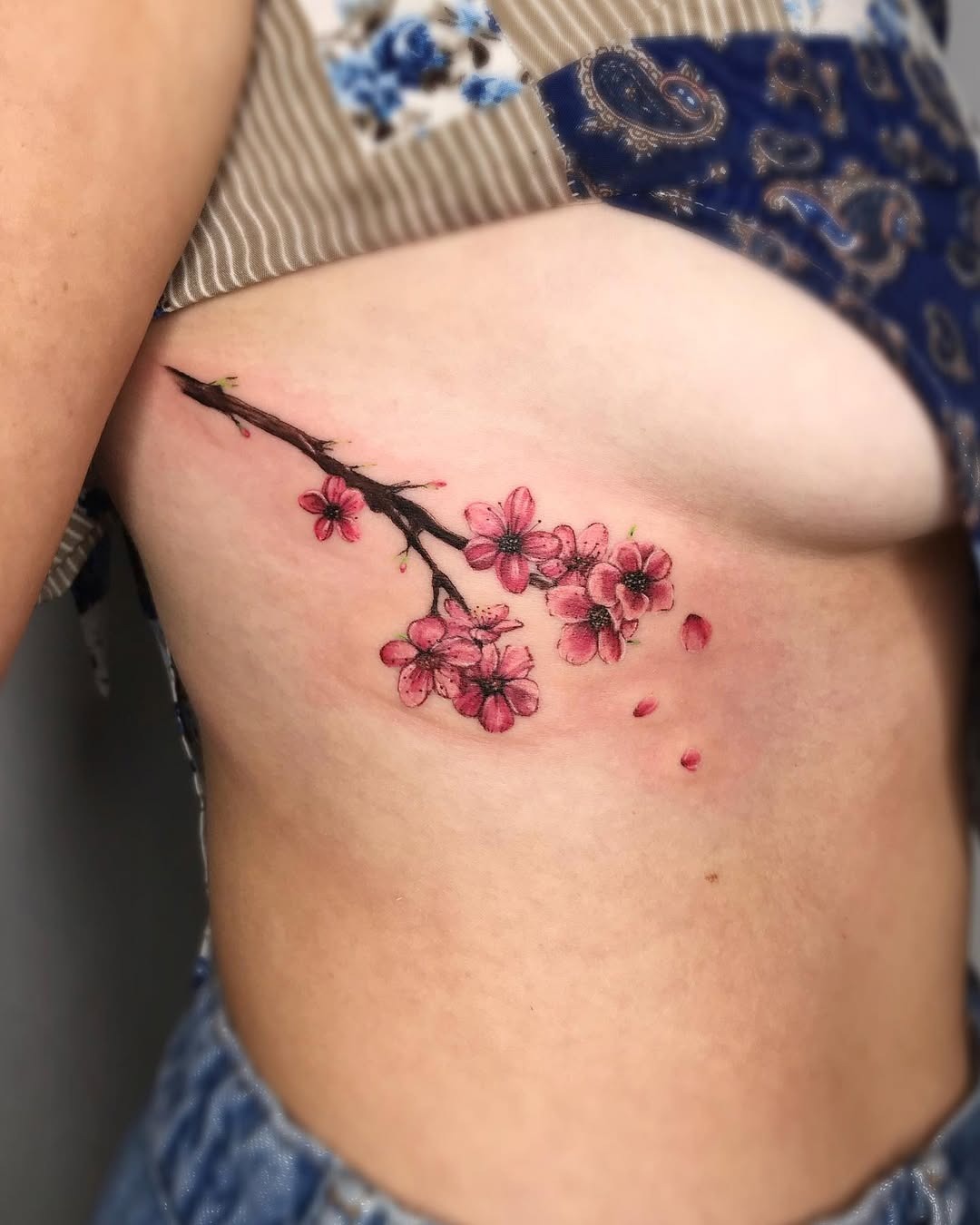 Delicate Rib Tattoo Featuring Pink Blossoms Tattoo Design