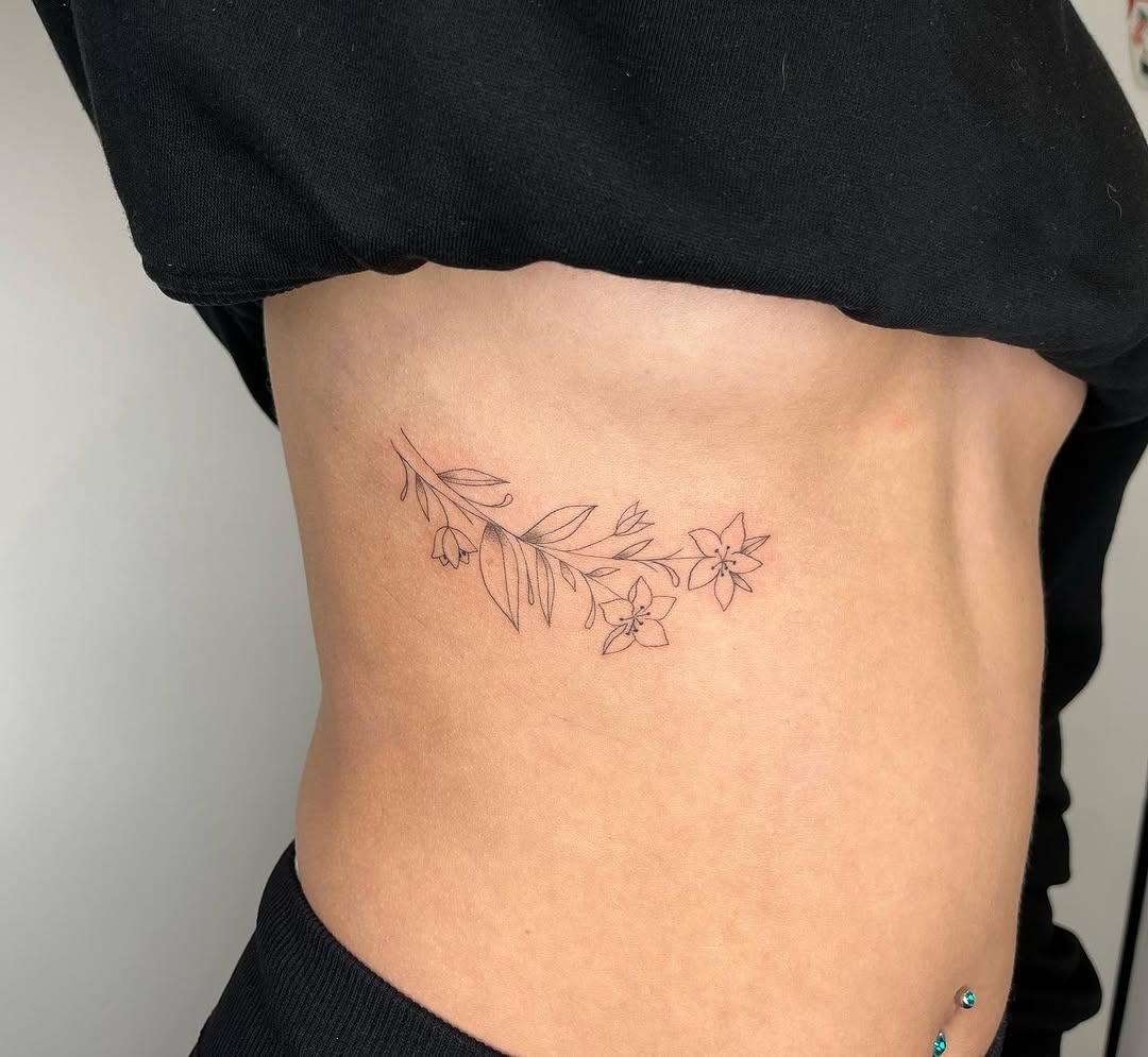 Elegant Floral Rib Tattoo: A Delicate Design Tattoo Design
