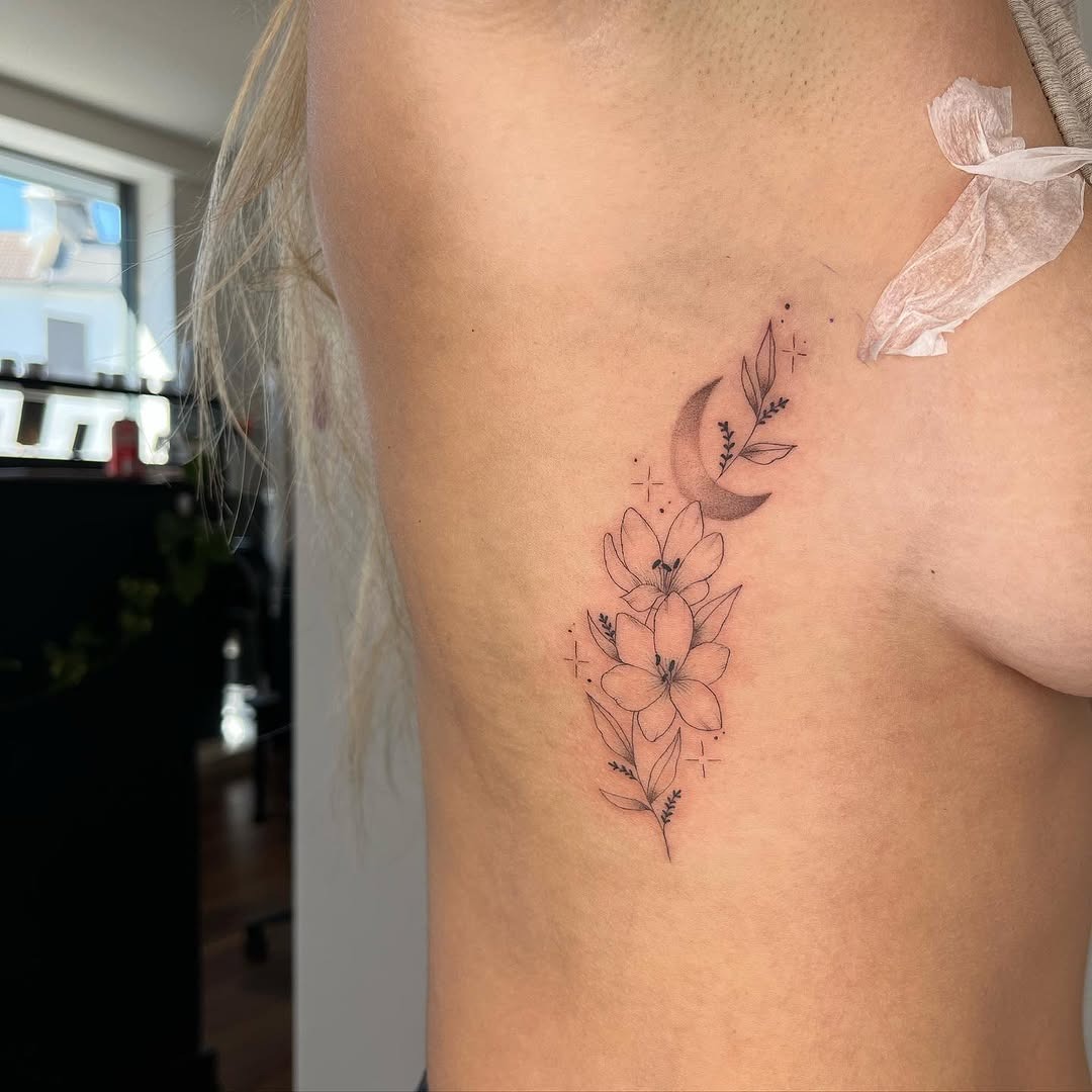 Elegant Rib Tattoo Featuring Moon and Flowers Tattoo Design