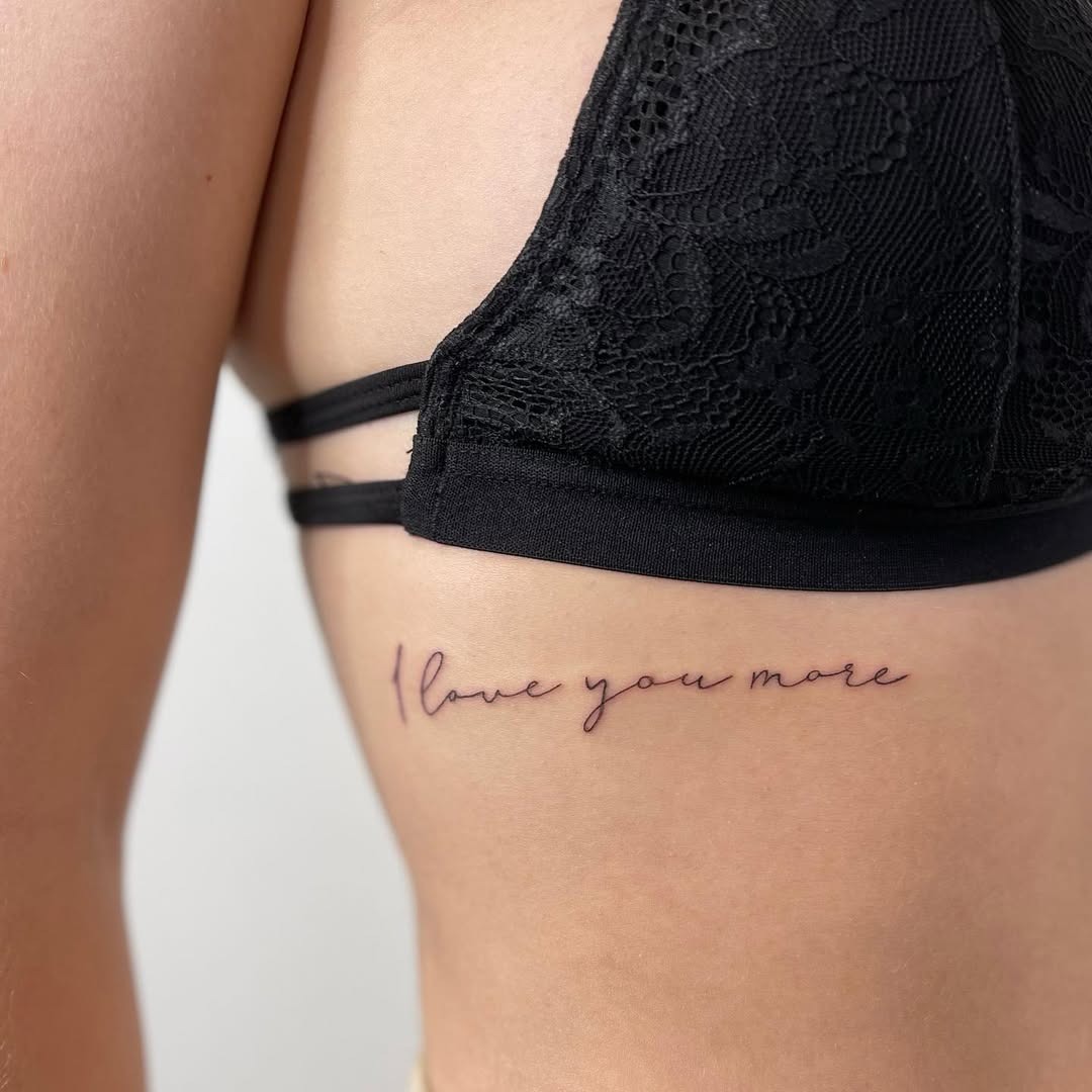 Elegant Rib Tattoo: Love You More Tattoo Design