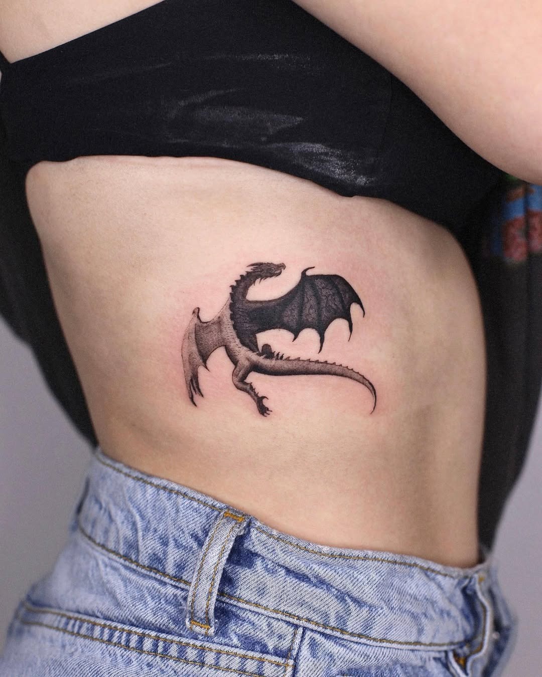 Stunning Dragon Rib Tattoo in Dark Shades Tattoo Design