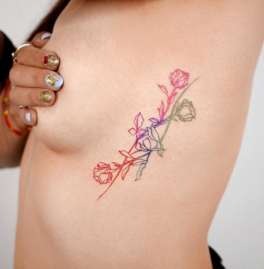 Stunning Rib Tattoo Featuring Colorful Flowers Tattoo Design
