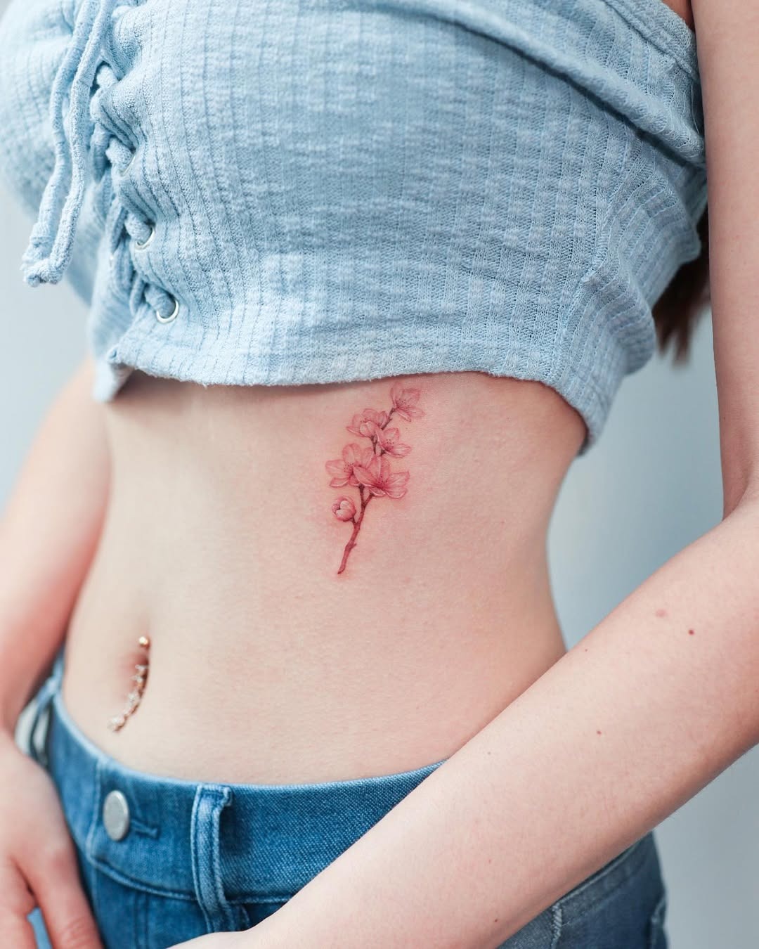 Stunning Rib Tattoo of a Delicate Flower Tattoo Design