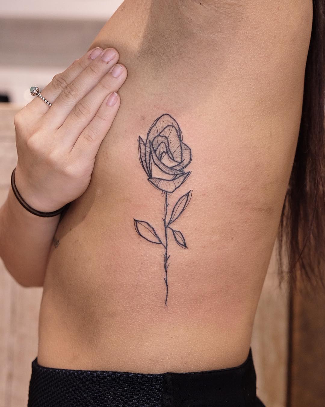 Stunning Rib Tattoo of a Delicate Rose Tattoo Design