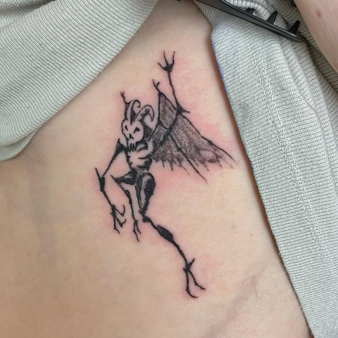Unique Rib Tattoo Design Featuring a Demon Tattoo Design