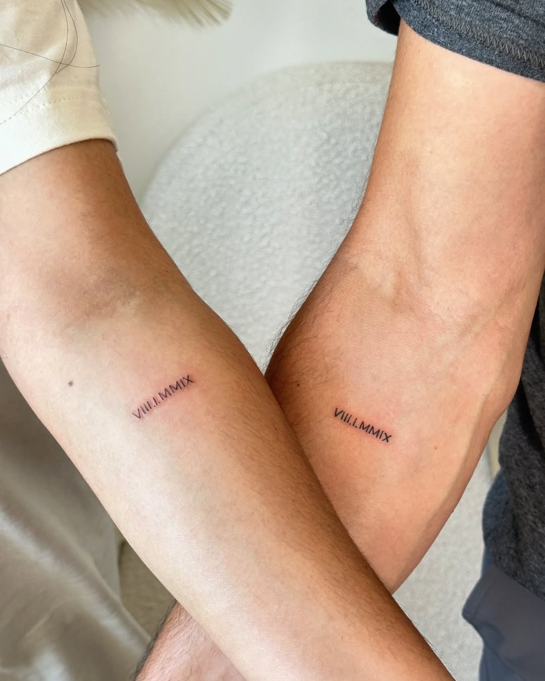 Couples’ roman numeral tattoo showcasing unity Tattoo Design