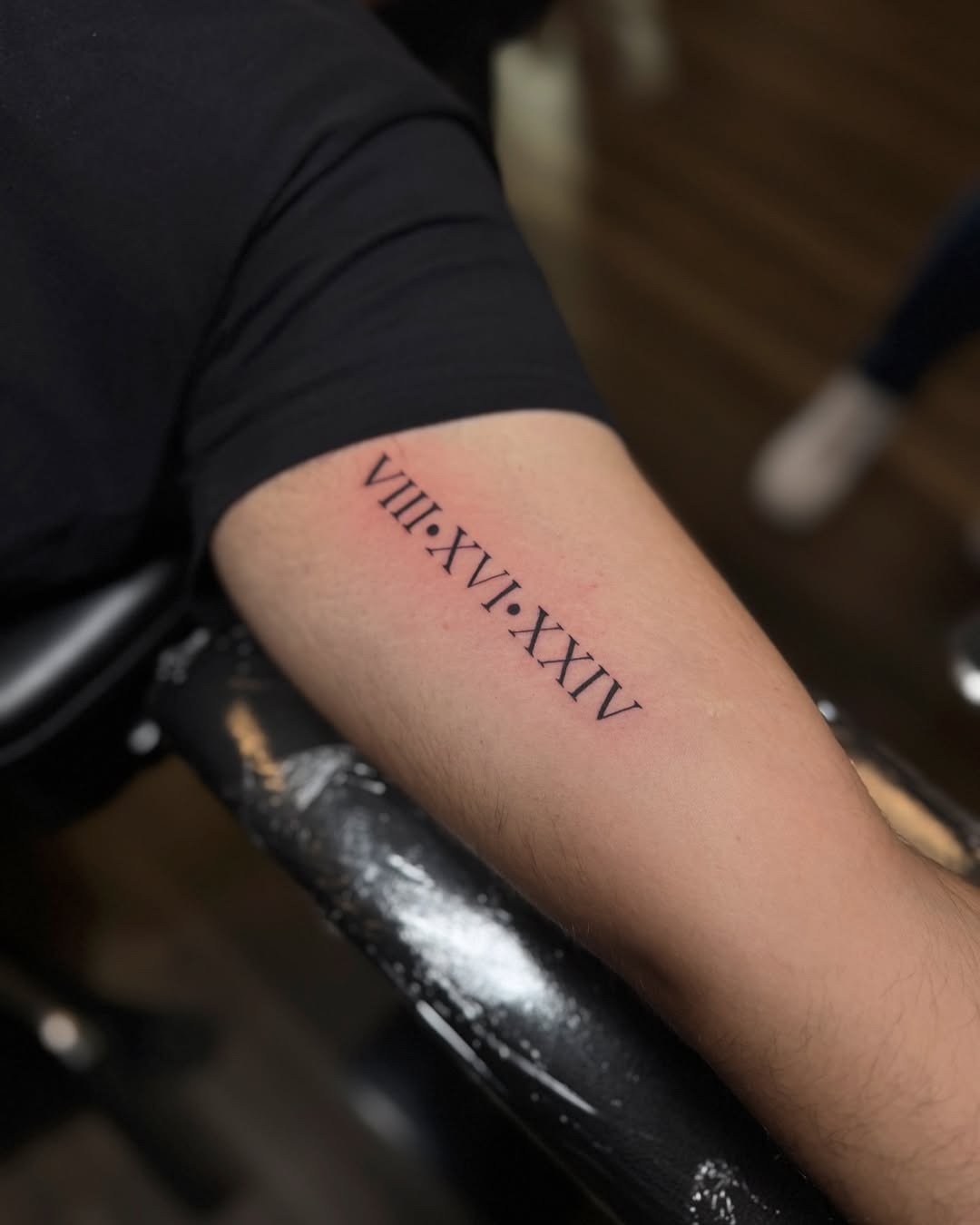 Elegant Roman Numerals Inked on the Arm Tattoo Design
