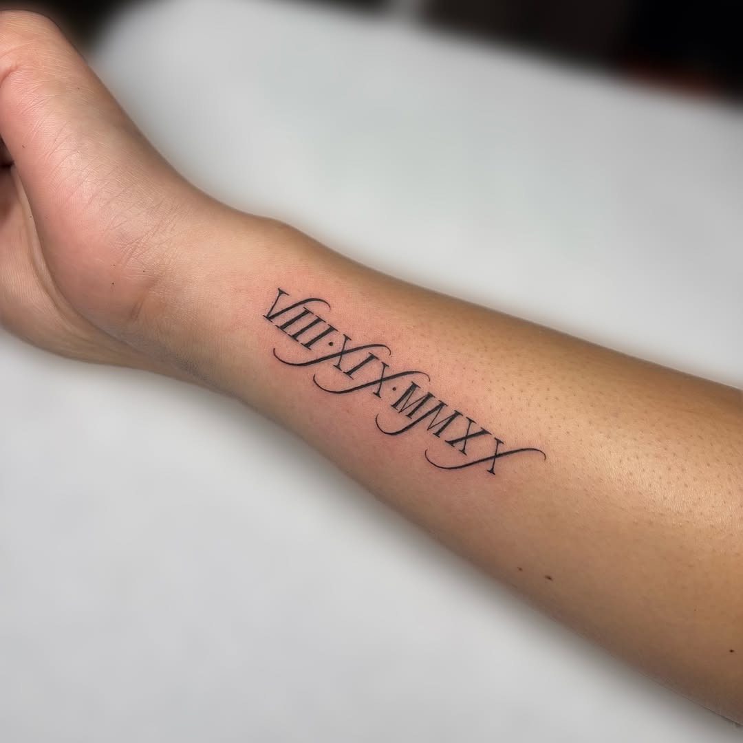 Elegant Roman Numerals on a Forearm Tattoo Design