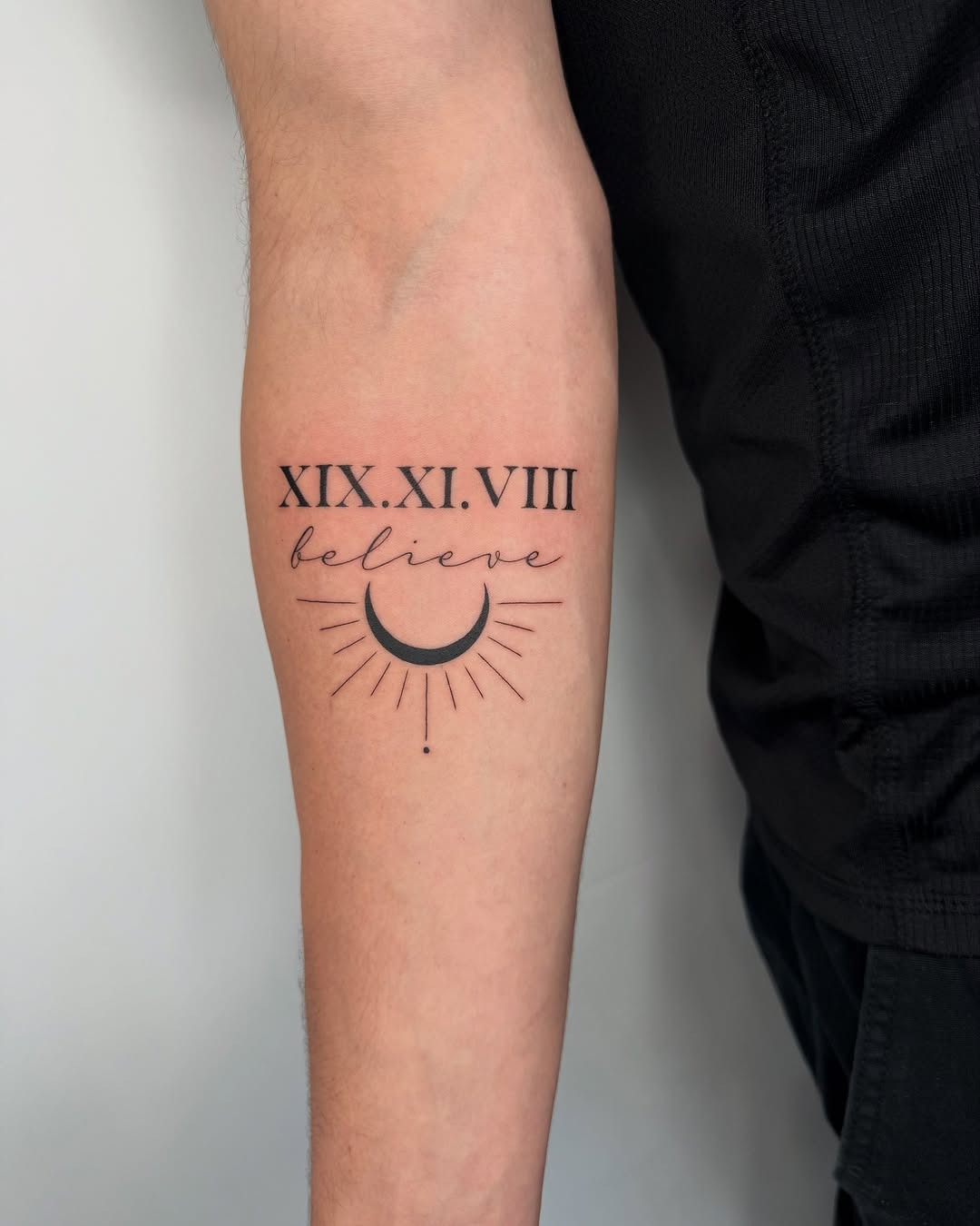 Roman numeral tattoo with celestial elements Tattoo Design