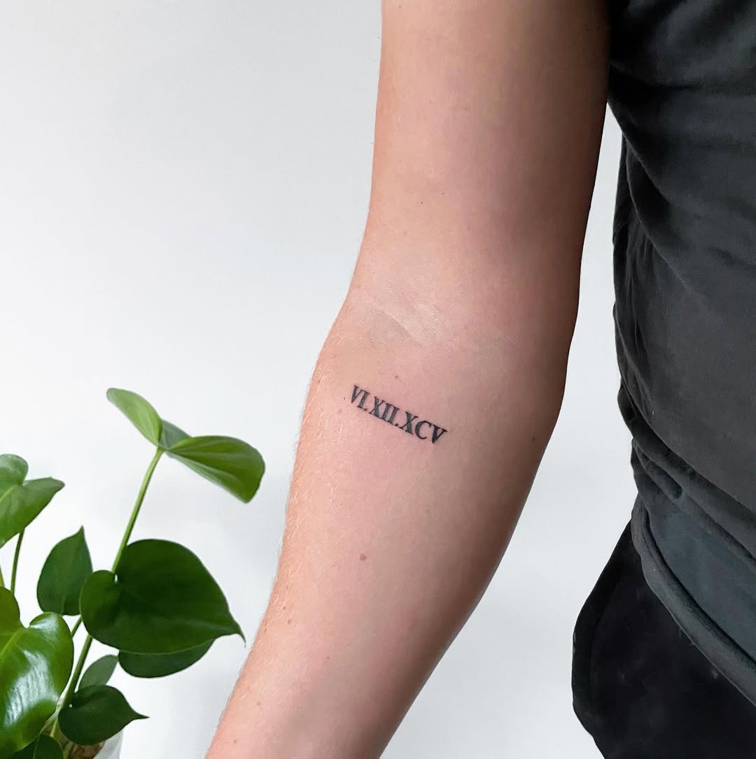 Stylish Roman numeral tattoo on forearm Tattoo Design