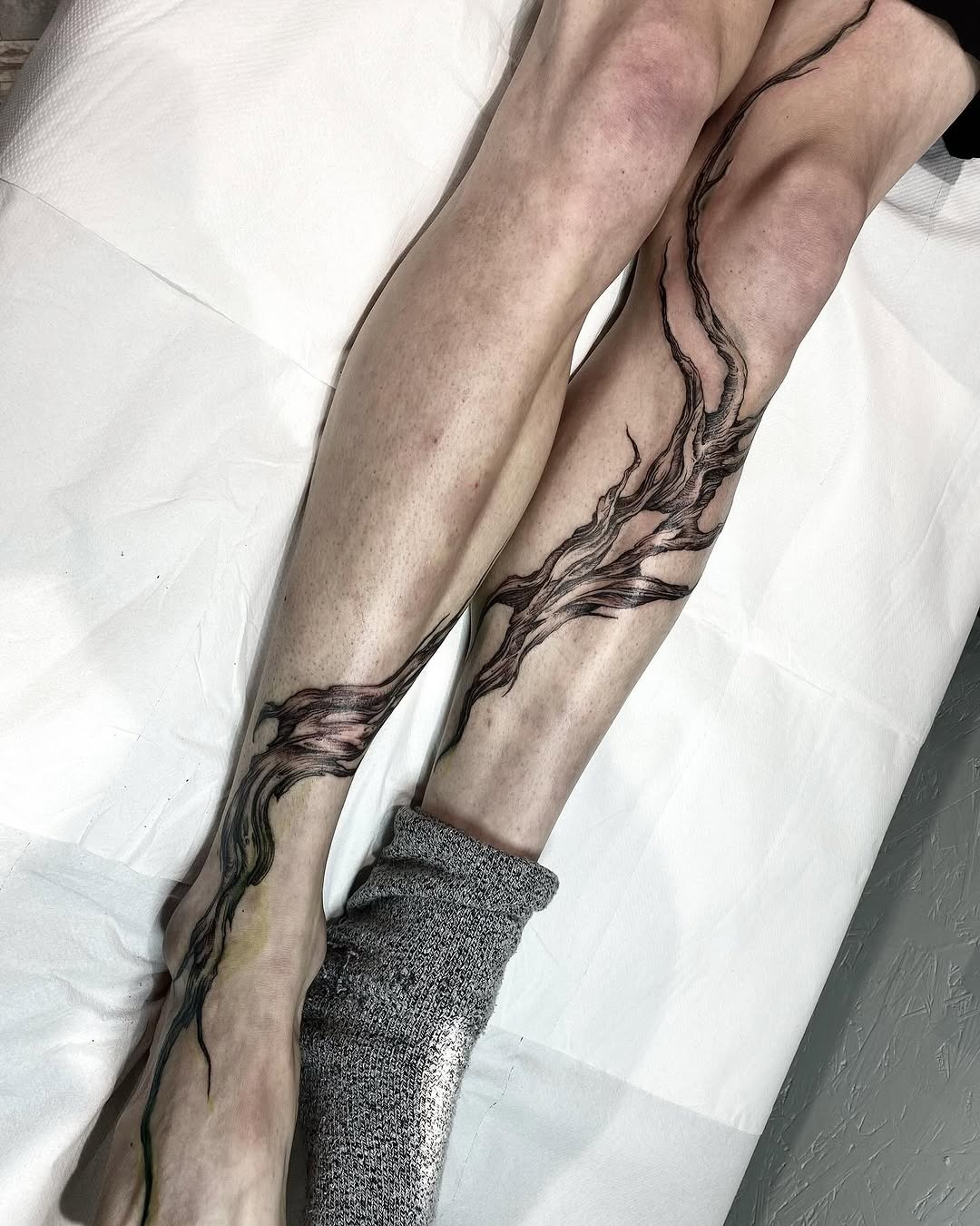 Artistic roots tattoo flowing down the leg Tattoo Design