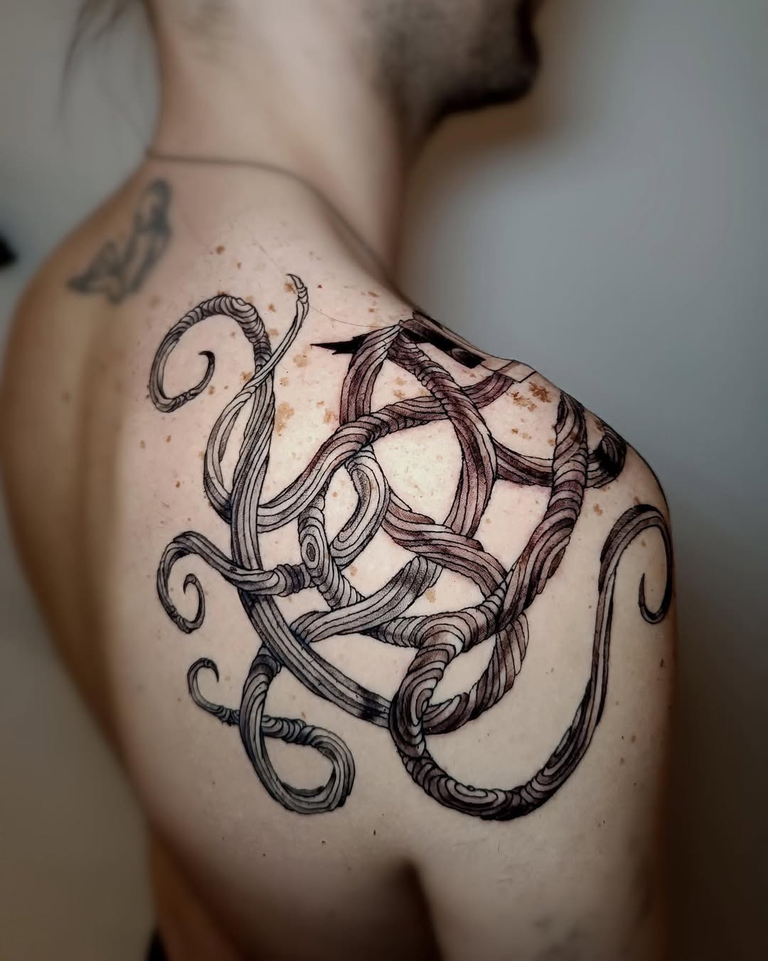Intricate roots tattoo with flowing octopus design Tattoo Design