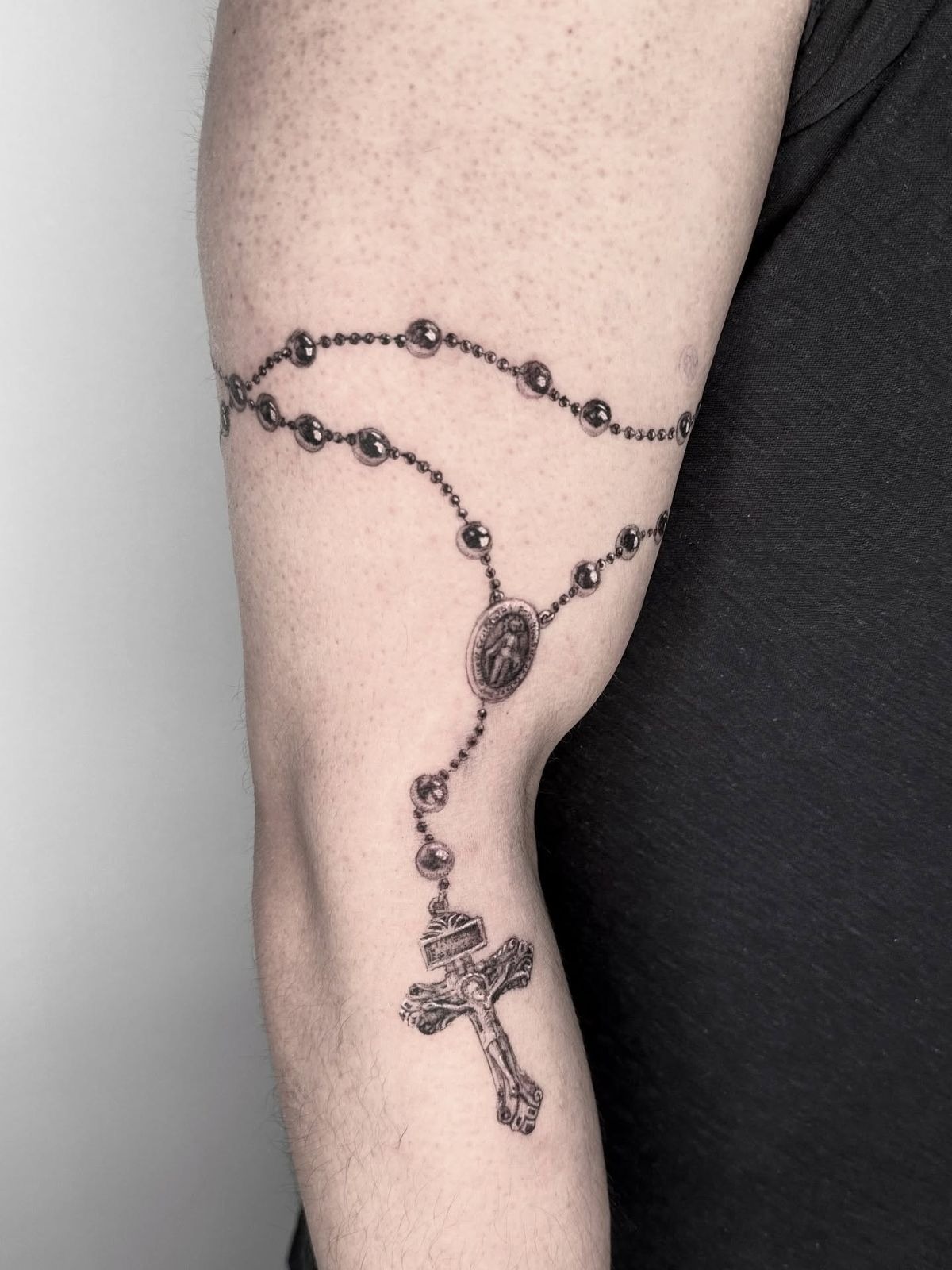 Realistic Rosary Around the Elbow Tattoo Design