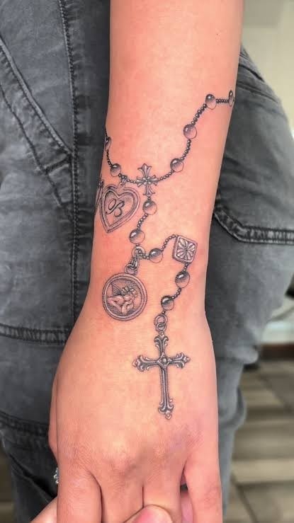 Rosary Hand Tattoo with Religious Charms Tattoo Design