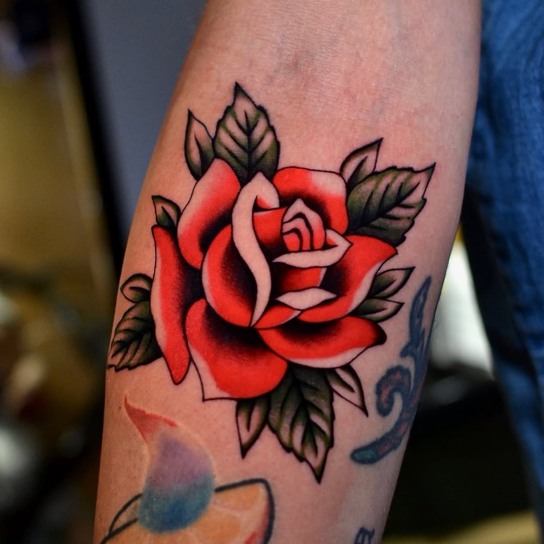 Bold and vibrant rose tattoo on the arm Tattoo Design