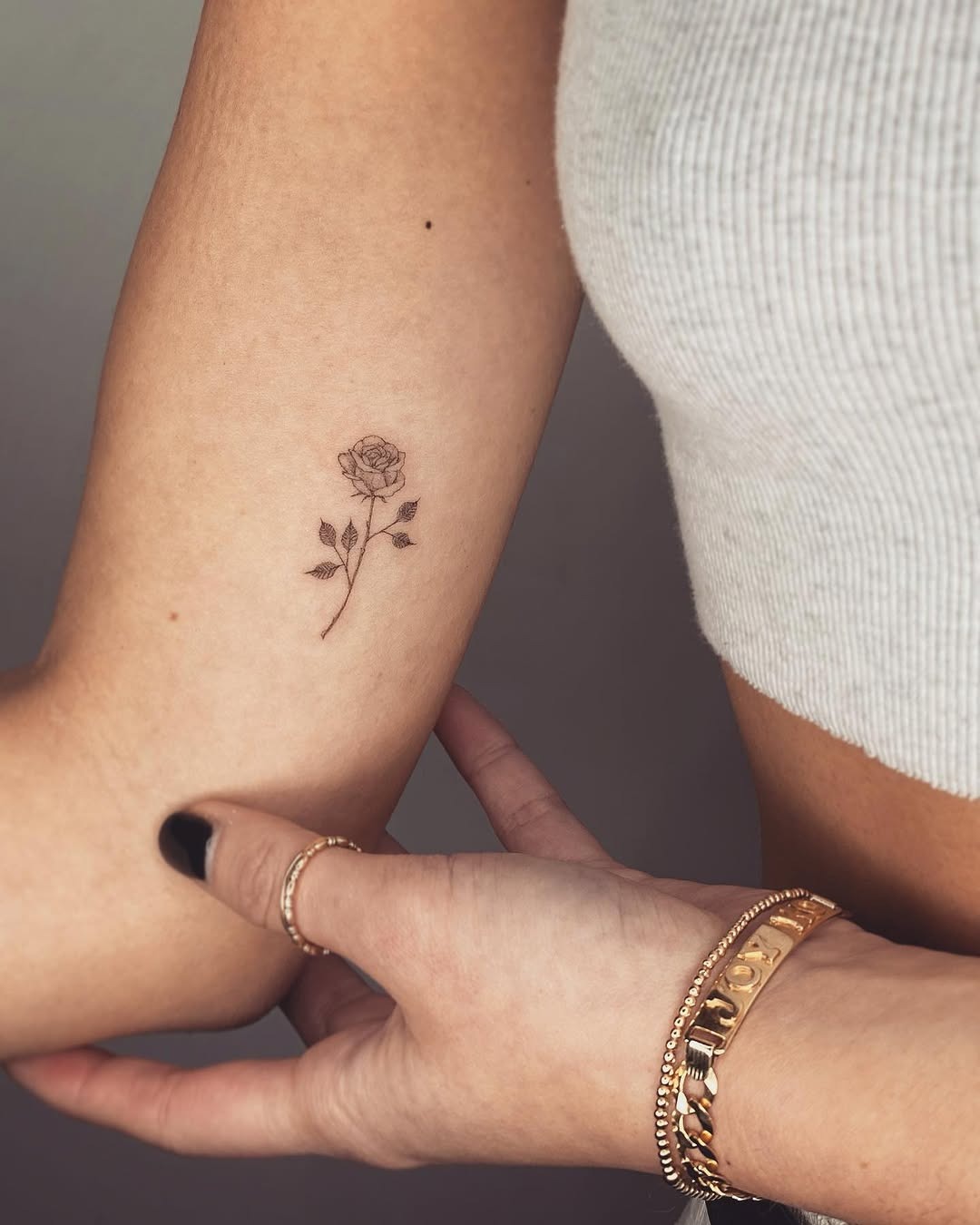 Delicate small rose tattoo on the arm Tattoo Design