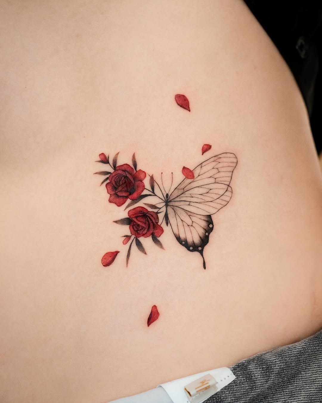 Delicate tattoo of a butterfly and roses Tattoo Design