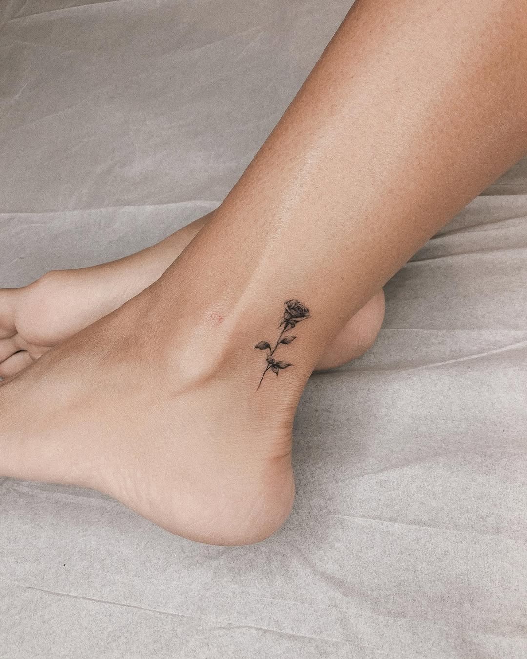 Elegant rose tattoo on ankle with minimalist design Tattoo Design