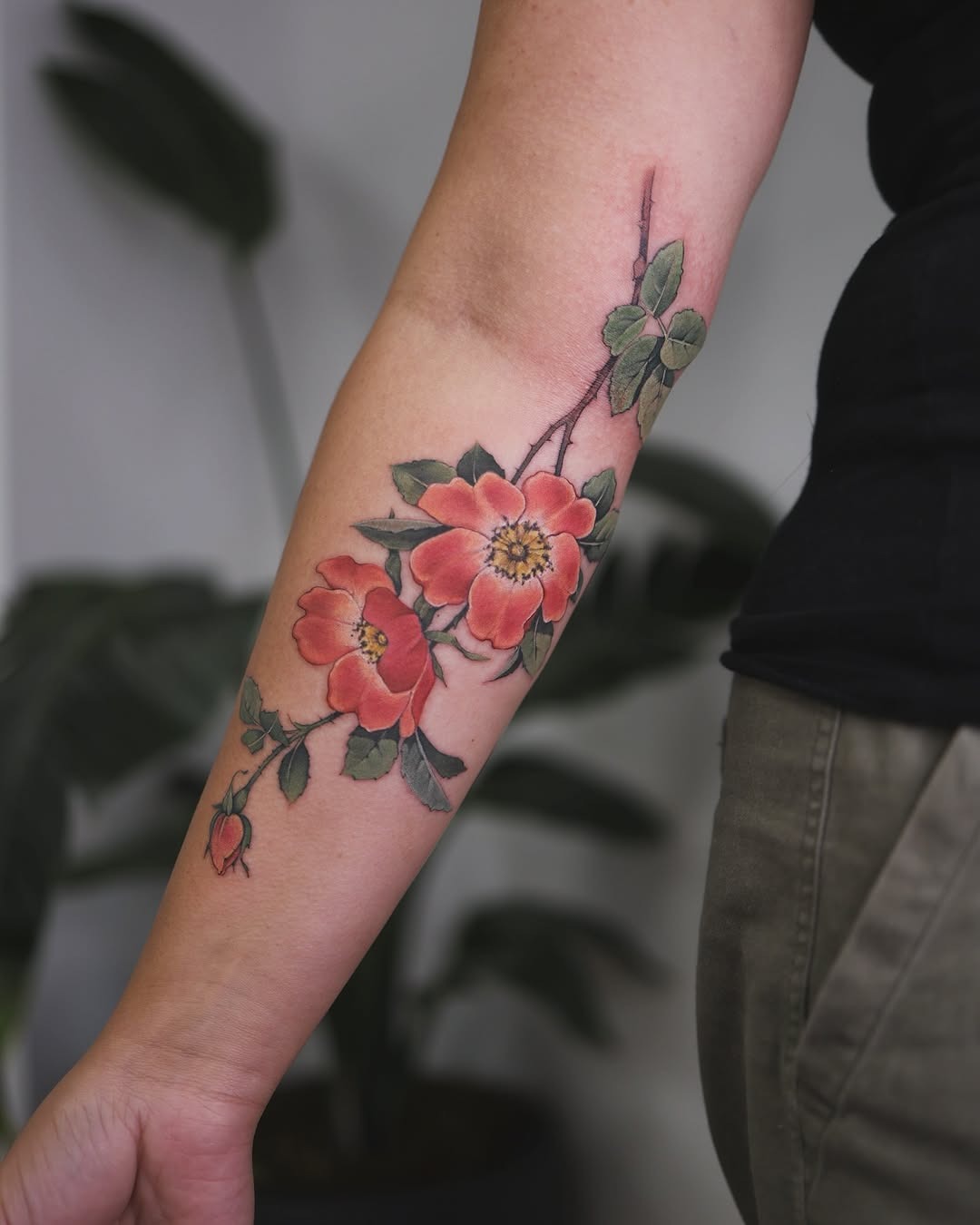 Stunning floral arm tattoo with vibrant roses Tattoo Design