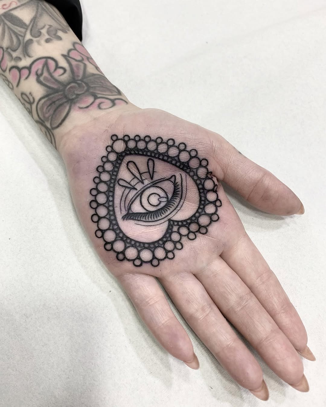 Intricate heart-shaped eye tattoo design Tattoo Design