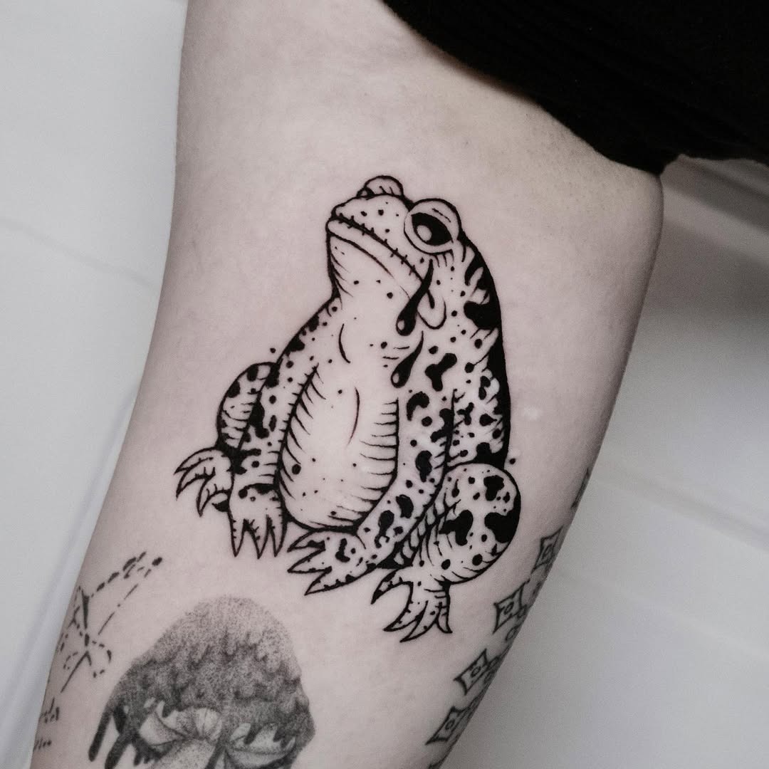 A melancholic frog tattoo capturing lost moments Tattoo Design