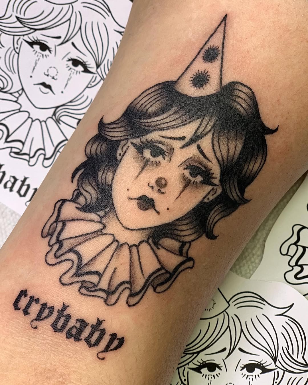 Melancholic clown tattoo showcases raw emotion Tattoo Design