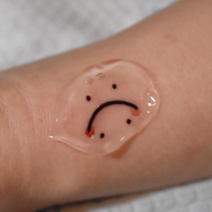 Sorrowful frown symbol inked on skin Tattoo Design