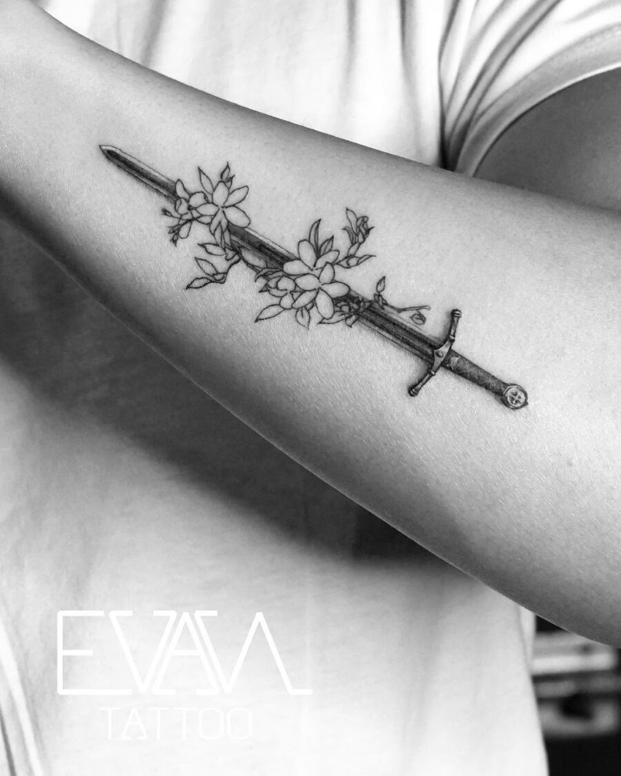Elegant sword entwined with sampaguita flowers Tattoo Design