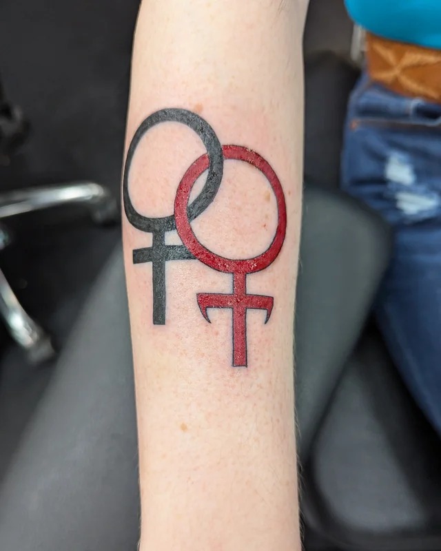 Feminine Symbol in Bold Tones Tattoo Design