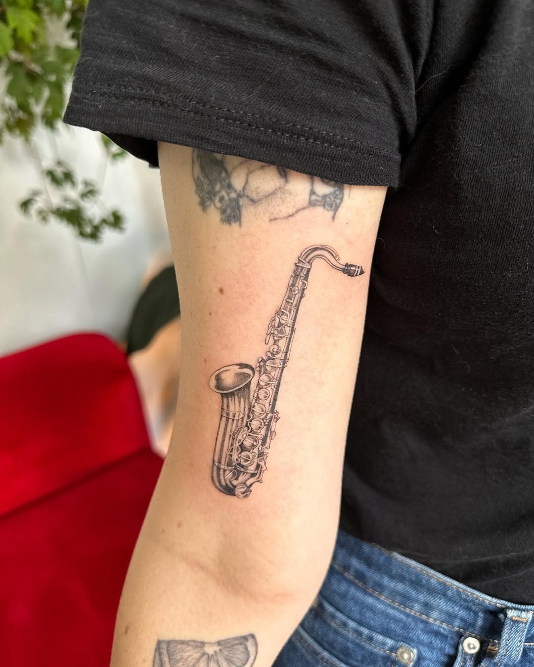 Elegant saxophone tattoo on forearm. Tattoo Design
