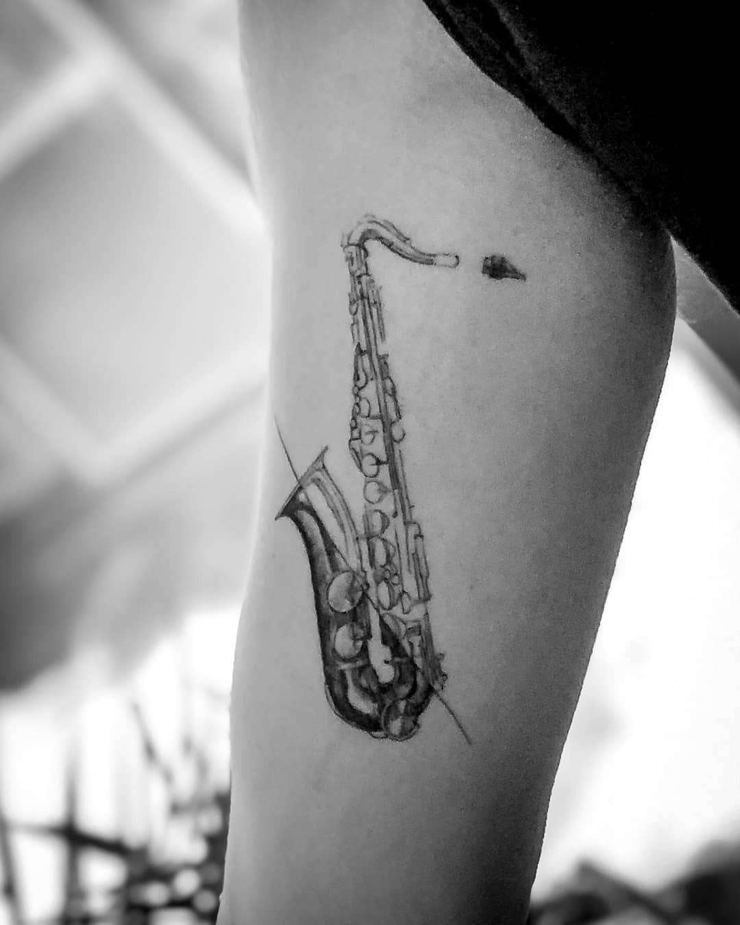 Intricate black and white saxophone tattoo design Tattoo Design