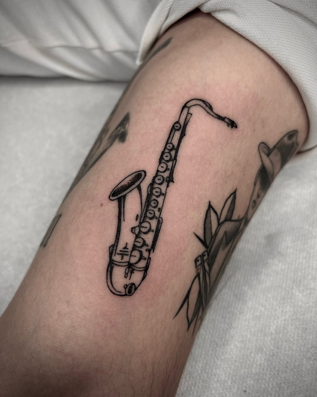 Minimalist saxophone tattoo showcasing musical passion Tattoo Design