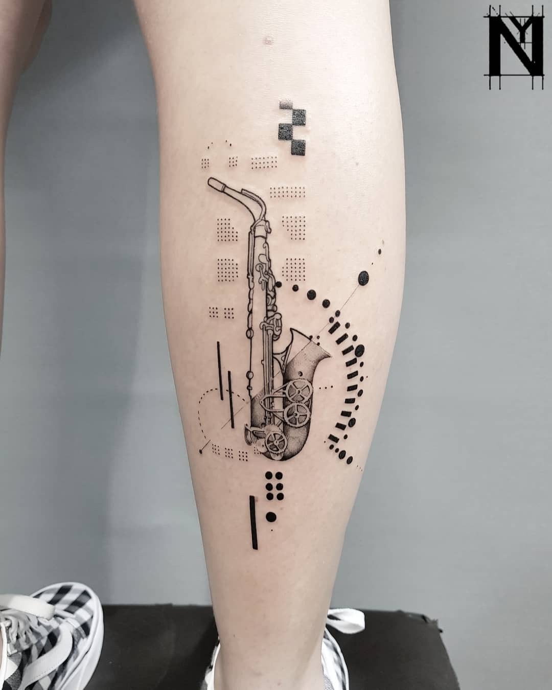 Minimalist saxophone tattoo with abstract elements Tattoo Design