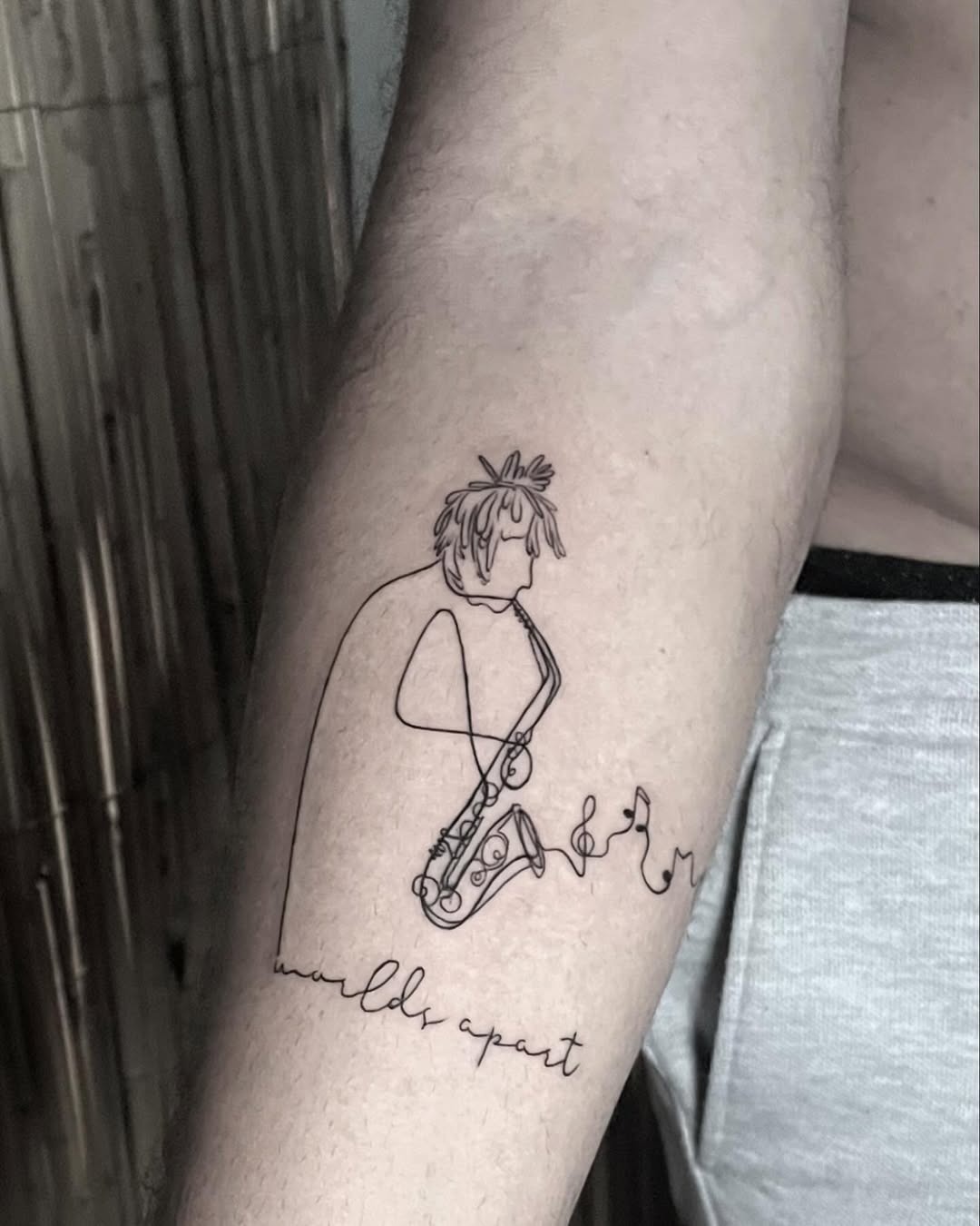 Minimalist saxophone tattoo with artistic flair Tattoo Design
