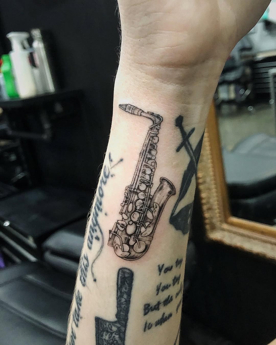 Stylish saxophone tattoo on the forearm Tattoo Design