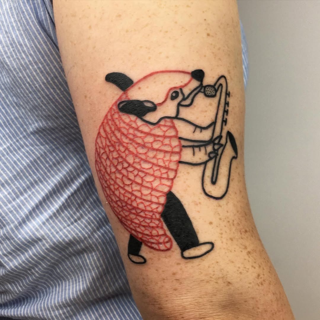 Unique saxophone tattoo featuring playful animal art Tattoo Design