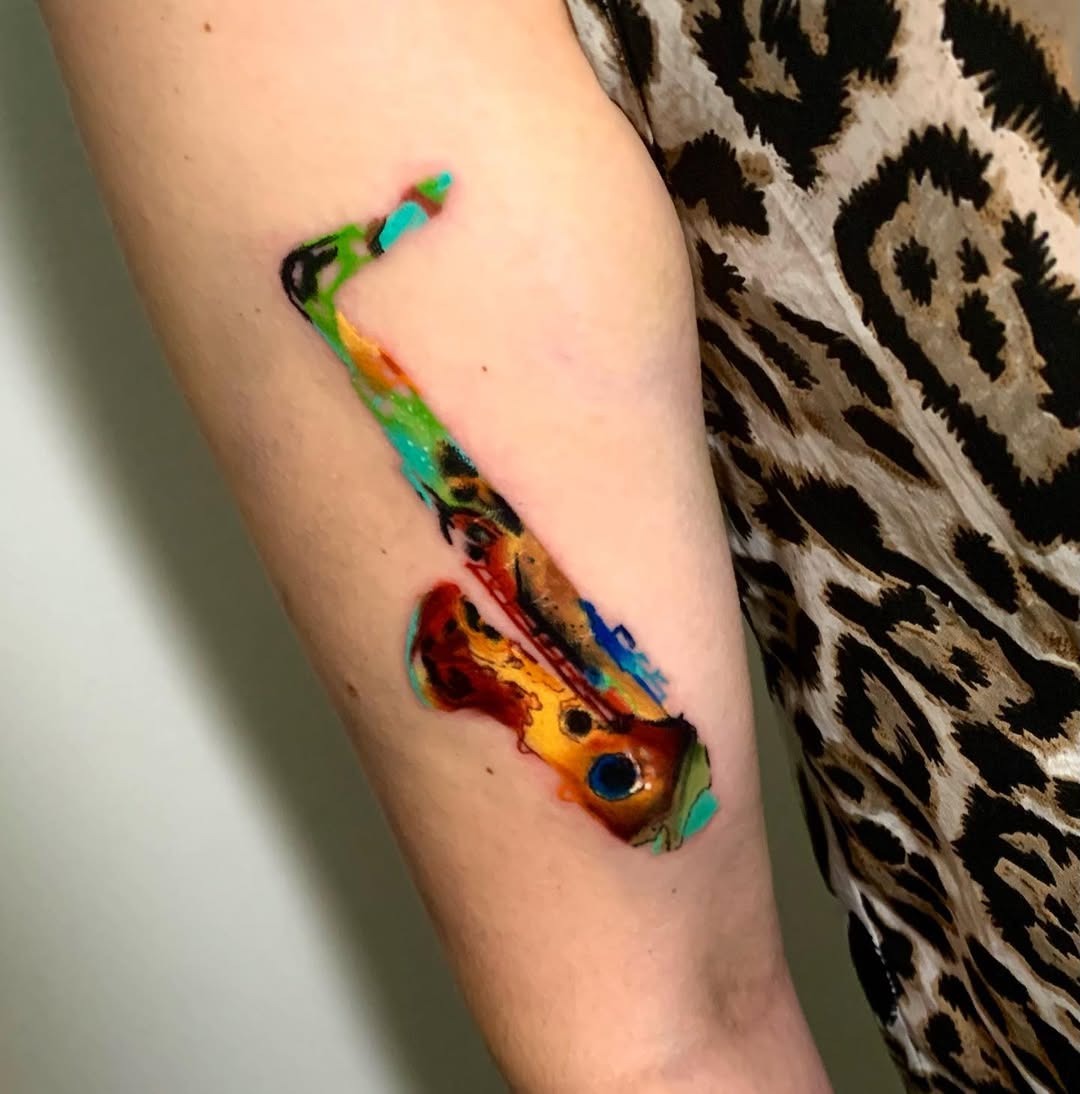 Vivid saxophone tattoo with artistic flair Tattoo Design