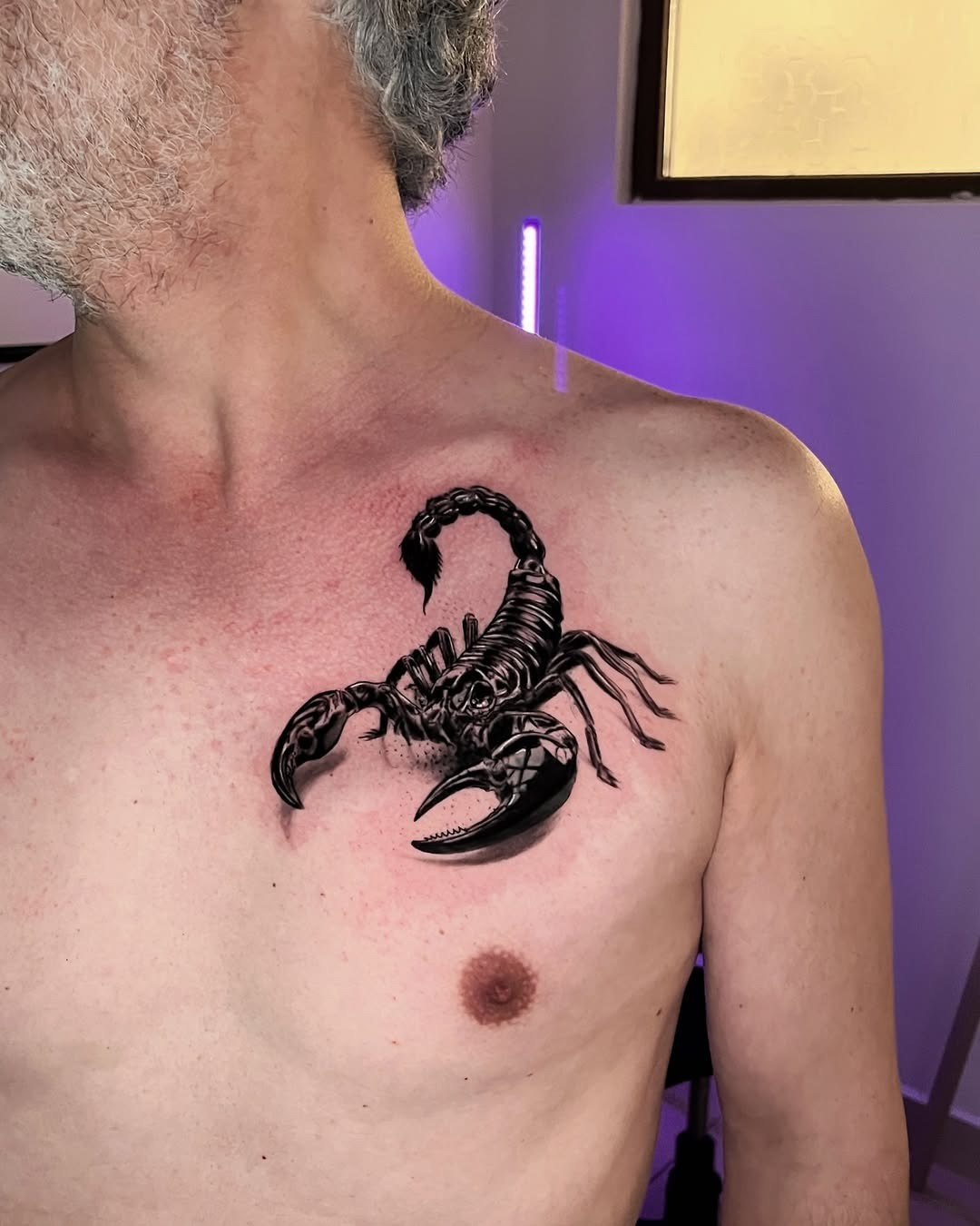 Bold scorpion tattoo on muscular chest Tattoo Design