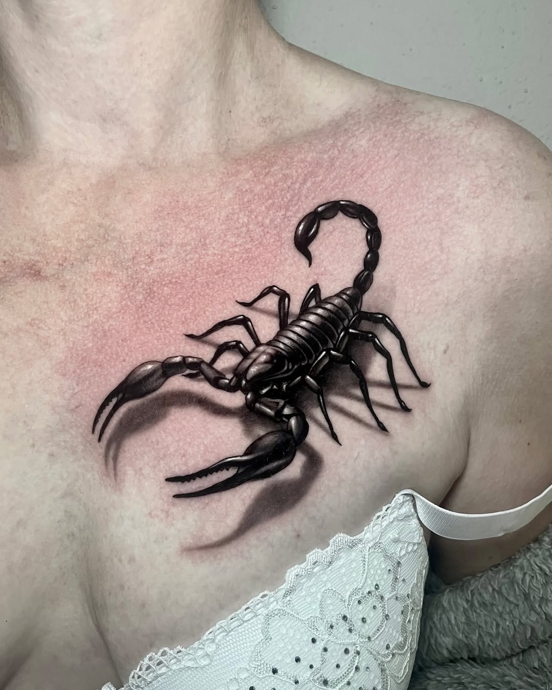 Bold scorpion tattoo on woman’s chest Tattoo Design