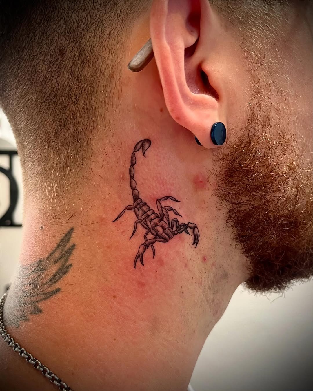 Intricate Scorpio tattoo near the ear Tattoo Design