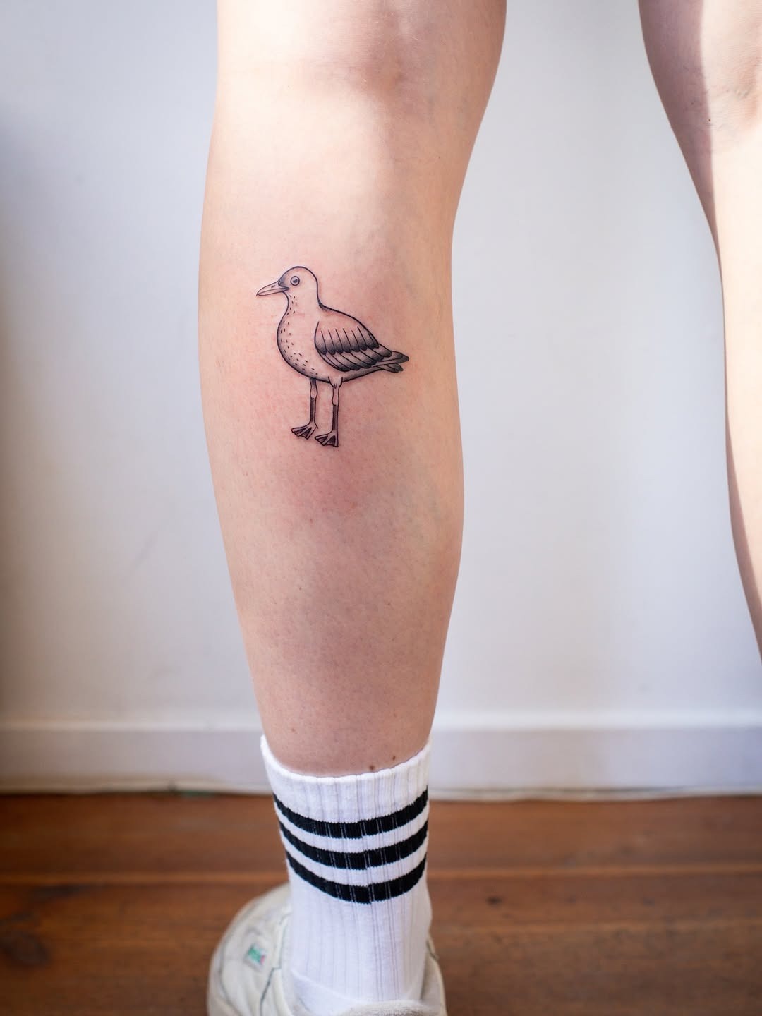 Minimalist seagull tattoo on leg Tattoo Design